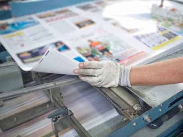 Photo of printer checking print machine at Sydney’s Fastest Printer